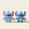 Two blue alien keychain finish options shown side by side