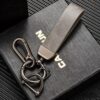 Gray leather car keychain with metal clip